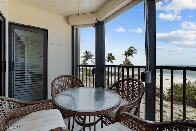 balcony with a beach view and a water view