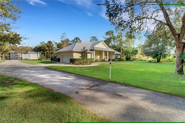 view of front of property with a front yard and a garage