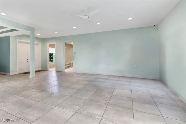 unfurnished room featuring light tile patterned floors and ceiling fan