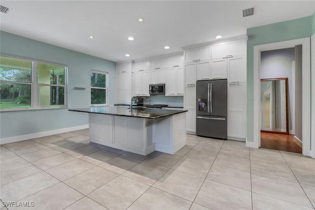 kitchen featuring appliances with stainless steel finishes, a center island with sink, white cabinetry, and sink