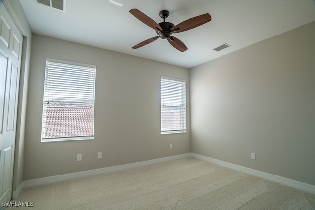 carpeted empty room featuring ceiling fan