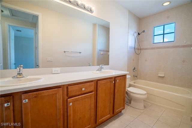 full bathroom featuring toilet, tiled shower / bath combo, tile patterned floors, and vanity