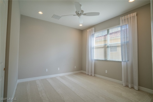 carpeted spare room with ceiling fan