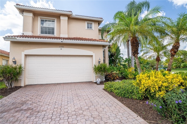 mediterranean / spanish-style house with a garage