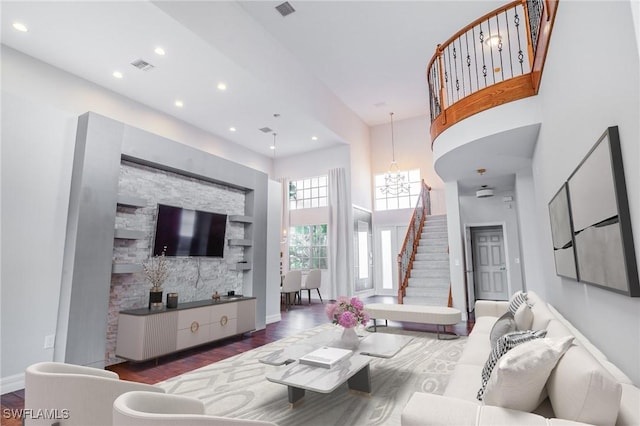 living room featuring a high ceiling and dark hardwood / wood-style flooring