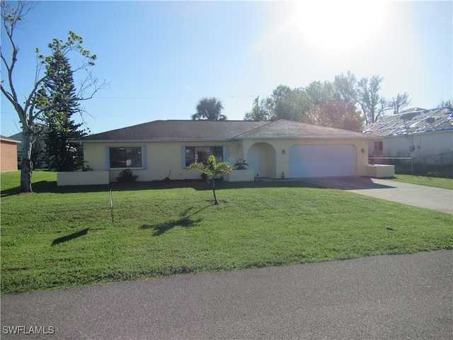 single story home featuring a front lawn and a garage