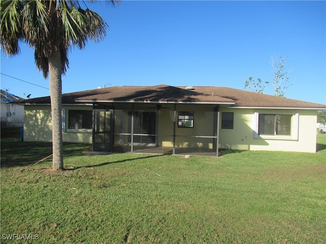 rear view of house with a yard