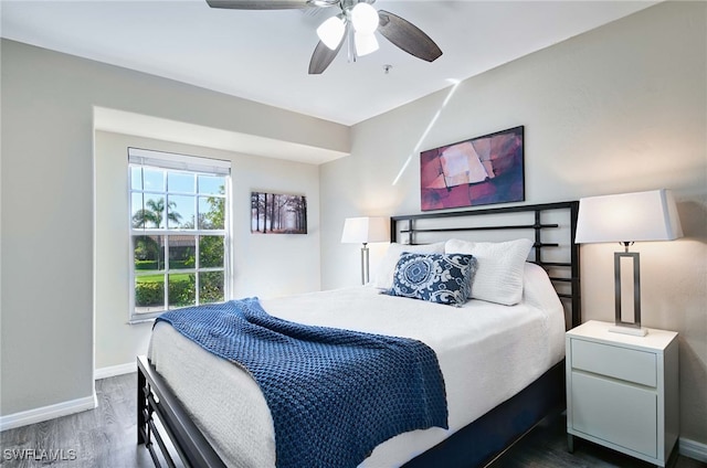 bedroom with ceiling fan and dark hardwood / wood-style floors