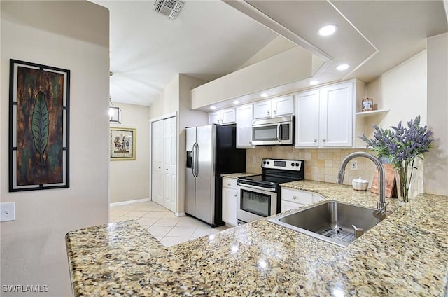 28080 Cavendish Ct Unit 2007, Bonita Springs, FL 34135 - kitchen featuring stainless steel appliances, open shelves, decorative backsplash, light stone countertops, and white cabinets