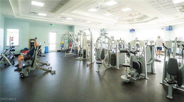 workout area featuring a raised ceiling