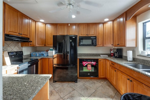 kitchen with backsplash, black appliances, ceiling fan, light tile patterned floors, and stone countertops