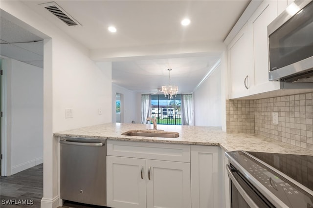 kitchen with white cabinetry, sink, stainless steel appliances, and dark hardwood / wood-style floors