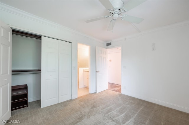 unfurnished bedroom with ceiling fan, a closet, light carpet, and ornamental molding