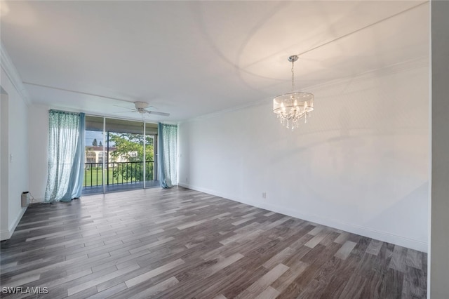 empty room with expansive windows, ornamental molding, ceiling fan with notable chandelier, and hardwood / wood-style flooring