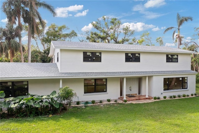 8531 Yorkshire Ln, Fort Myers, FL 33919 - view of front of property featuring roof with shingles and a front lawn