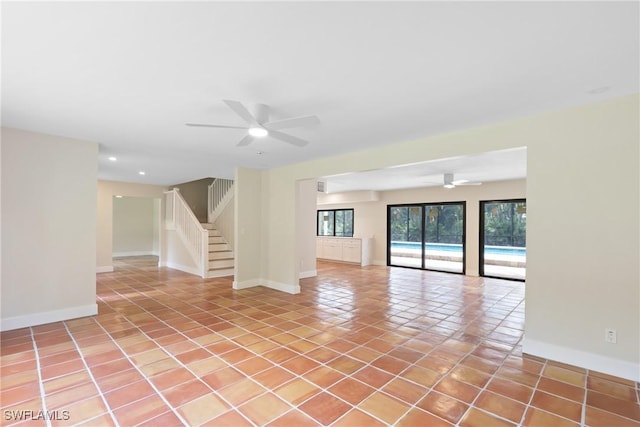 8531 Yorkshire Ln, Fort Myers, FL 33919 - empty room with a ceiling fan, stairway, light tile patterned flooring, baseboards, and recessed lighting
