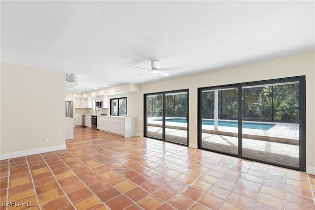 8531 Yorkshire Ln, Fort Myers, FL 33919 - unfurnished living room featuring light tile patterned floors, baseboards, and a ceiling fan