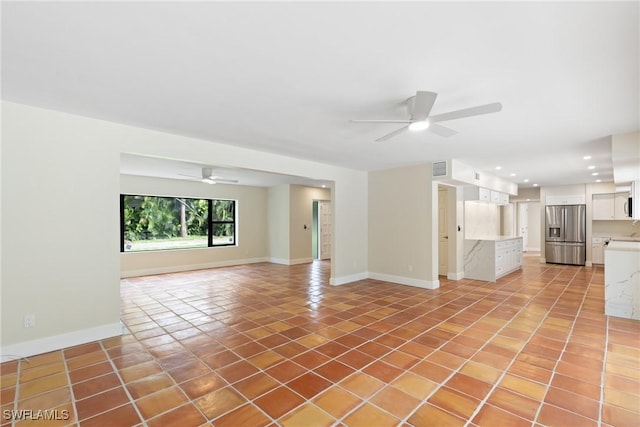 8531 Yorkshire Ln, Fort Myers, FL 33919 - unfurnished living room with ceiling fan, light tile patterned flooring, baseboards, recessed lighting, and a sink