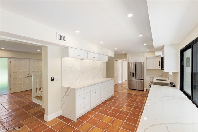 8531 Yorkshire Ln, Fort Myers, FL 33919 - kitchen with appliances with stainless steel finishes, tile patterned floors, white cabinetry, light stone countertops, and recessed lighting