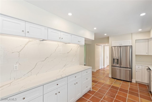 8531 Yorkshire Ln, Fort Myers, FL 33919 - kitchen featuring stainless steel fridge, tasteful backsplash, white cabinetry, dark tile patterned flooring, and recessed lighting