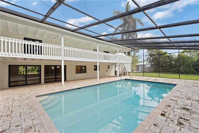 view of swimming pool with a patio area and a lanai