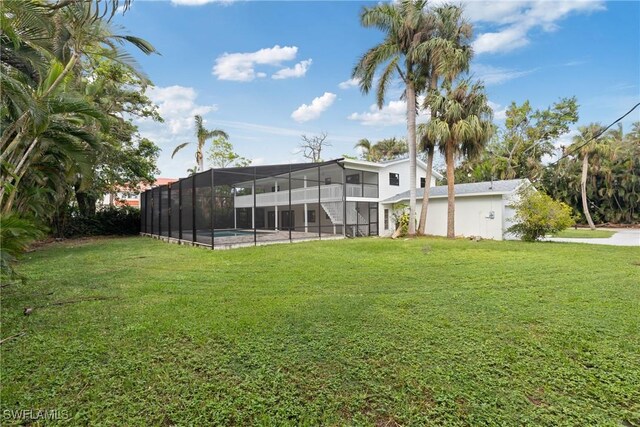 8531 Yorkshire Ln, Fort Myers, FL 33919 - view of grassy yard with an outdoor pool and a lanai