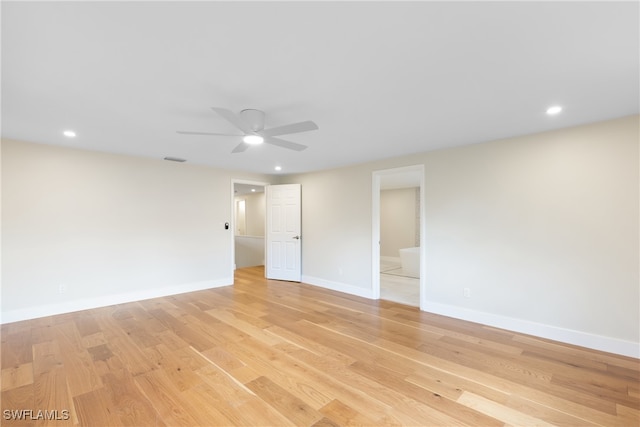 spare room featuring light hardwood / wood-style flooring and ceiling fan