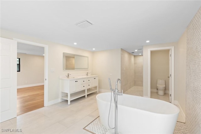 8531 Yorkshire Ln, Fort Myers, FL 33919 - full bath featuring double vanity, a freestanding tub, tiled shower, recessed lighting, and toilet
