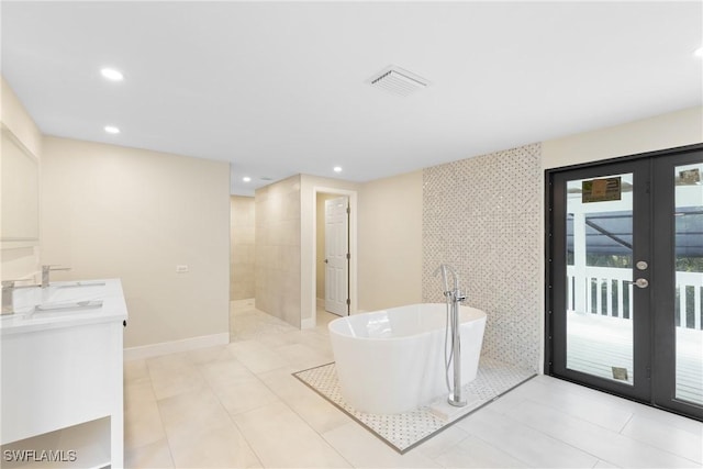 8531 Yorkshire Ln, Fort Myers, FL 33919 - full bathroom with french doors, a soaking tub, recessed lighting, double vanity, and walk in shower