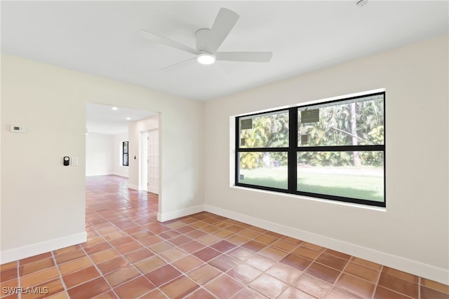 unfurnished room with ceiling fan and light tile patterned floors