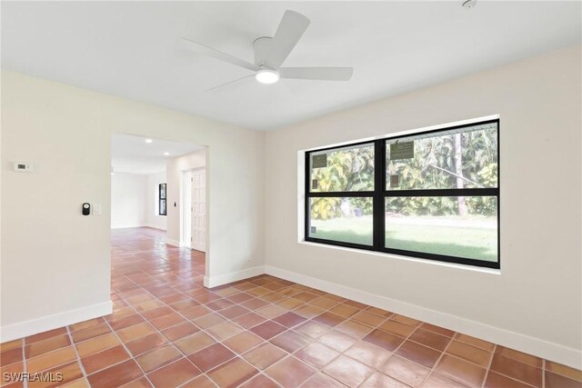 8531 Yorkshire Ln, Fort Myers, FL 33919 - empty room with baseboards, plenty of natural light, tile patterned floors, and a ceiling fan