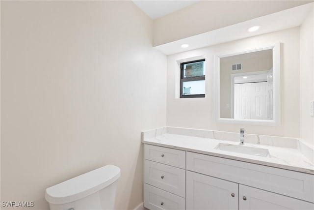 8531 Yorkshire Ln, Fort Myers, FL 33919 - half bathroom featuring vanity, toilet, and recessed lighting