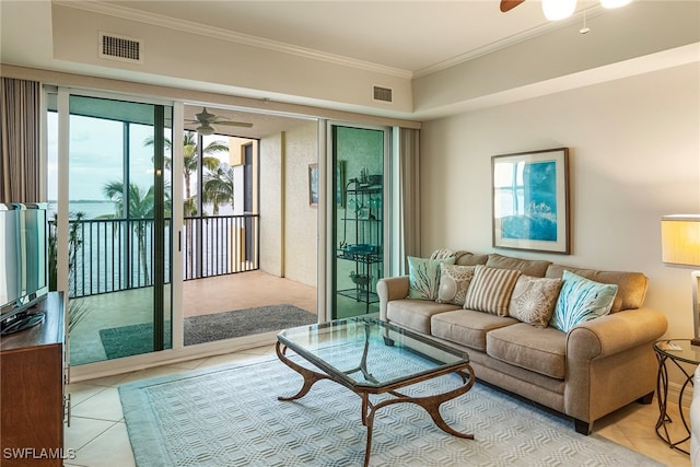 tiled living room featuring crown molding and ceiling fan