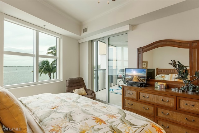 bedroom featuring access to exterior, crown molding, and a water view