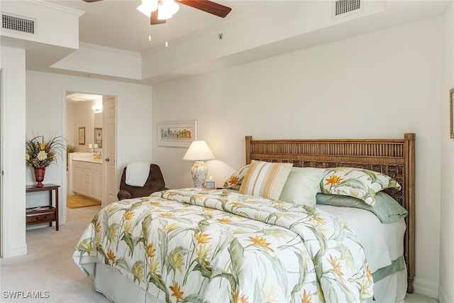 carpeted bedroom featuring ornamental molding, ceiling fan, and ensuite bath