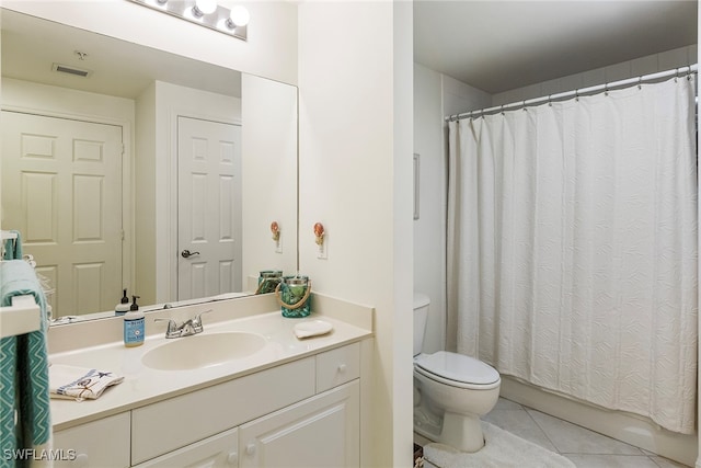 bathroom featuring vanity, toilet, and tile patterned flooring