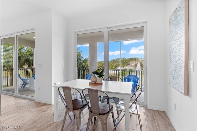 dining space with light wood-type flooring