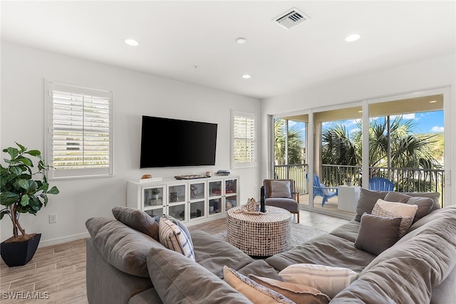 living room with light hardwood / wood-style floors and plenty of natural light