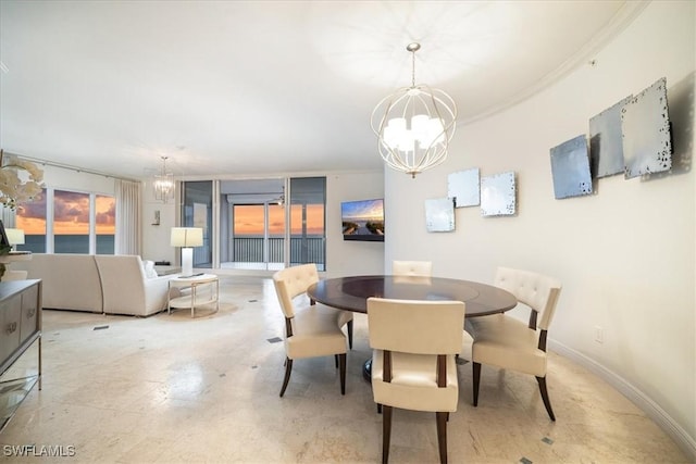 dining area featuring a chandelier and crown molding