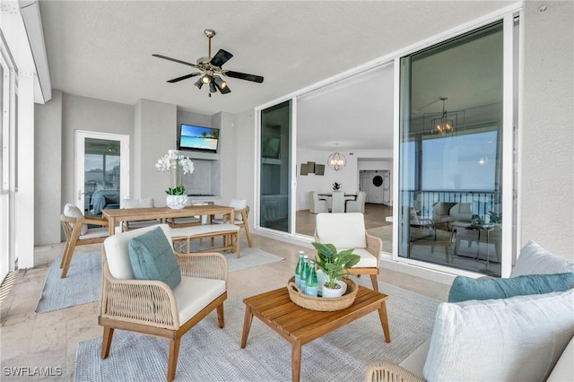 sunroom / solarium with washer / dryer and ceiling fan with notable chandelier