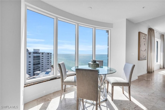 dining space featuring a water view