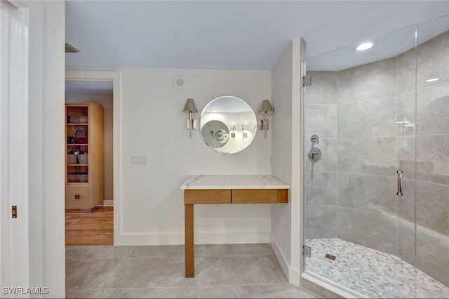 bathroom with tile patterned flooring and walk in shower