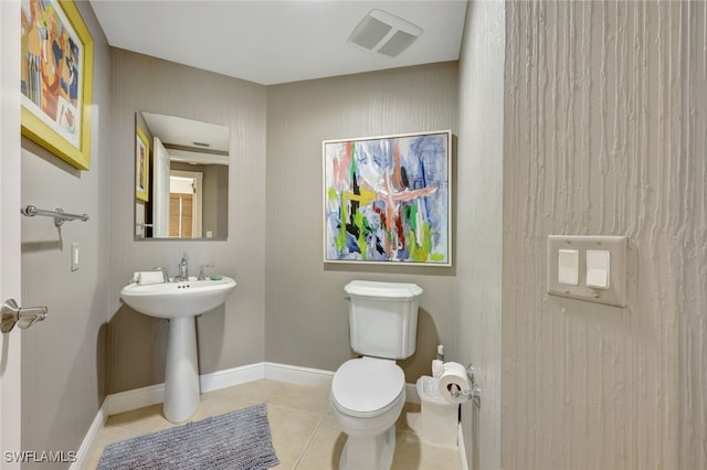 bathroom with tile patterned flooring and toilet