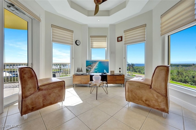 6081 Silver King Blvd Unit 206, Cape Coral, FL 33914 - living area featuring a tray ceiling, a ceiling fan, and light tile patterned flooring