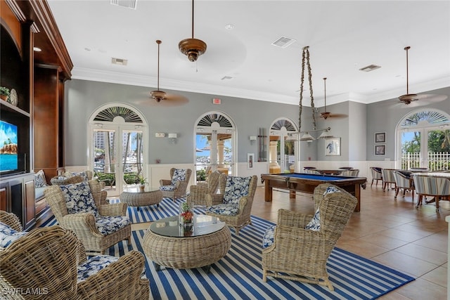 tiled living room with french doors, ornamental molding, plenty of natural light, and pool table