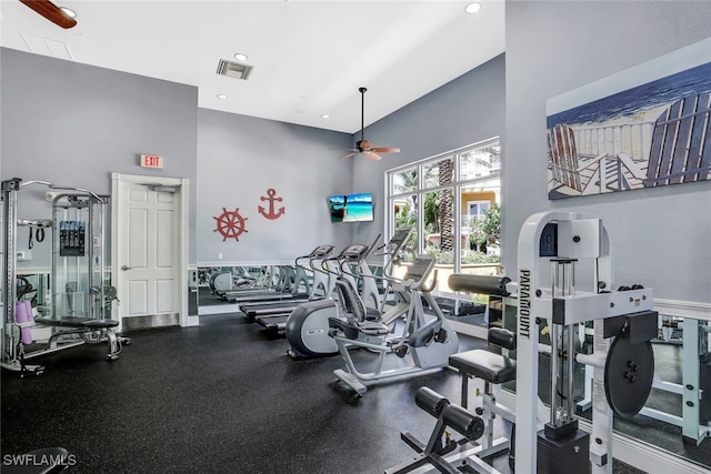 workout area featuring a high ceiling and ceiling fan