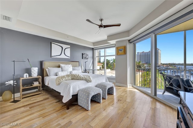 bedroom with access to outside, ceiling fan, and light hardwood / wood-style floors