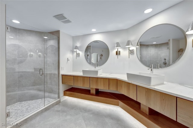 bathroom featuring vanity and an enclosed shower