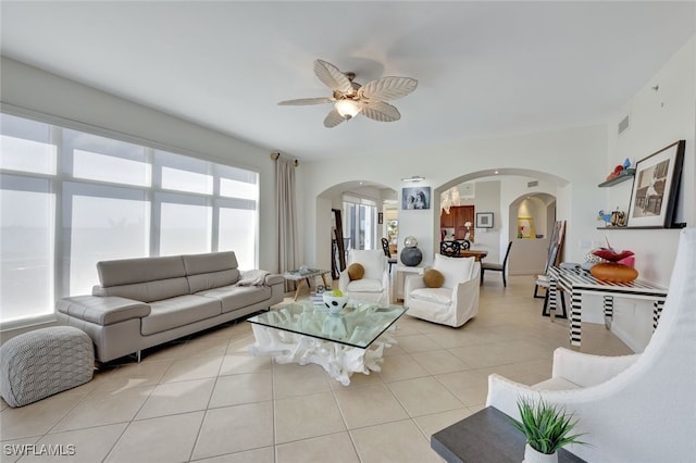 tiled living room with ceiling fan