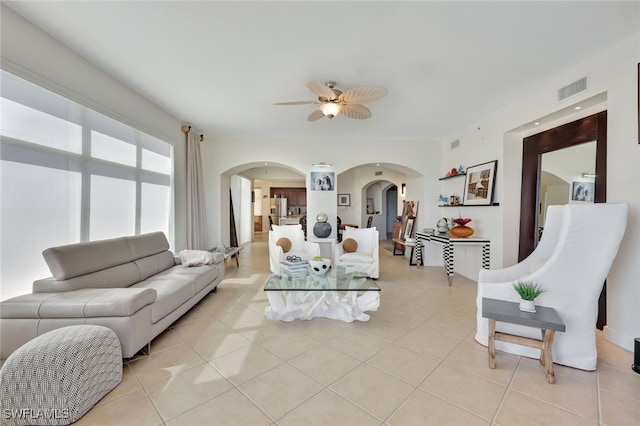 living room with ceiling fan and light tile patterned flooring